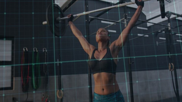 Woman bracing and breathing, pulling then pressing bar overhead while grid tracing path for fitness