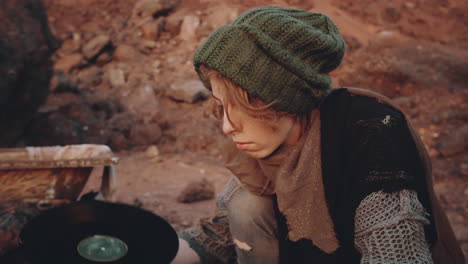 woman taking old stuff from box in dystopian world