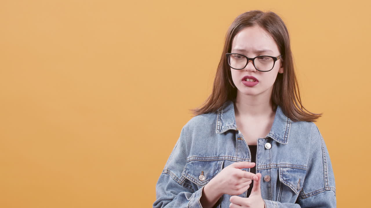 Teenage girl with glasses in denim jacket
