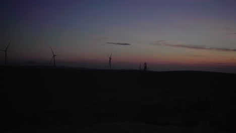 Windmills-at-sunrise-along-the-White-Sand-Dunes-in-Mui-Ne,-Phan-Thiet,-Vietnam