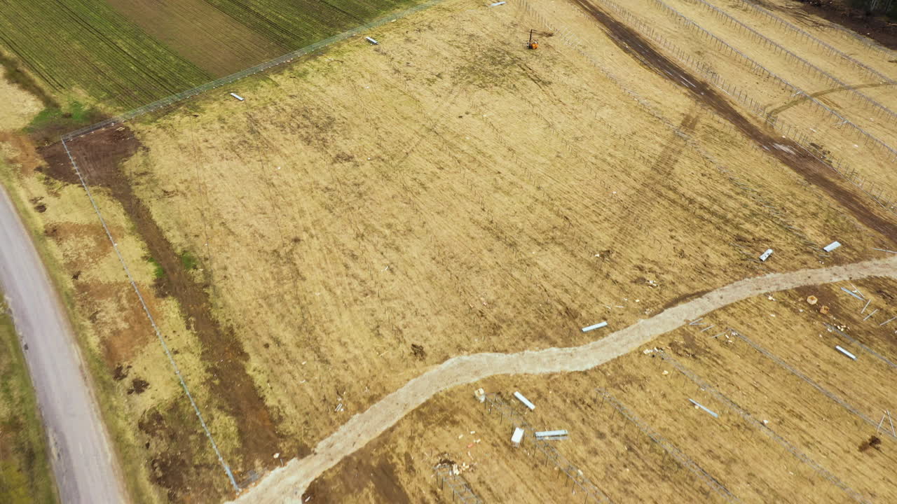 Land preparation process for solar panel farm in countryside area, aerial view