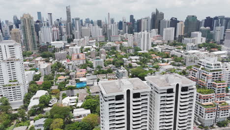high rise buildings at phrom phong cityscape in bangkok, thailand. aerial drone shot