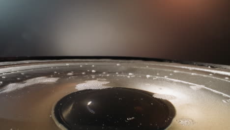 particles of white powder fall on water with foam in dynamic