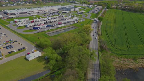 aerial drone view of group of large modern industrial warehouse or factory buildings in suburban city area