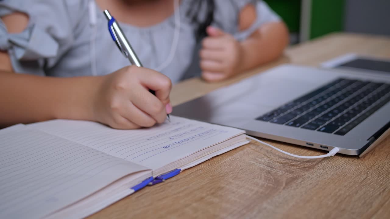Girl studying with laptop and notebook