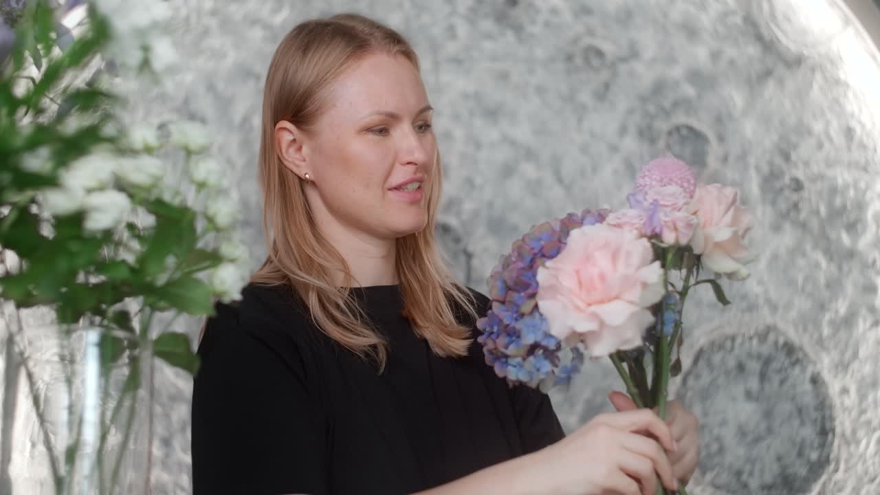 Woman Arranging a Bouquet of Flowers against a Moon Background