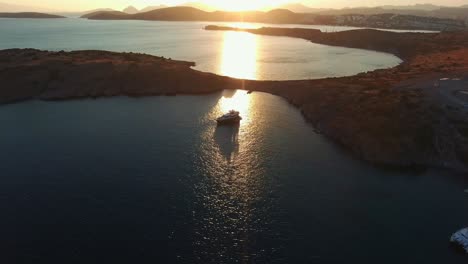 Drone-shot-of-the-boat-standing-in-the-bay-at-sunset