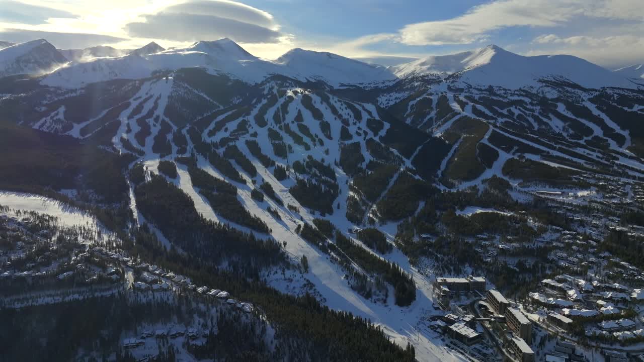 Breckenridge Ski Resort mountain town Colorado aerial drone sunset Winter December January skiing trails run Peak 9 10 Ten Mile Range Epic Vail Pass cirrus clouds chairlifts forward pan up motion
