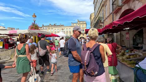 people explore vibrant market stalls in libourne