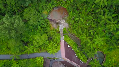 Aerial-view-approaching-Caldera-Velha-famous-hot-springs-in-tropical-island-of-Sao-Miguel