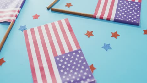 american flags with red and blue stars lying on blue background