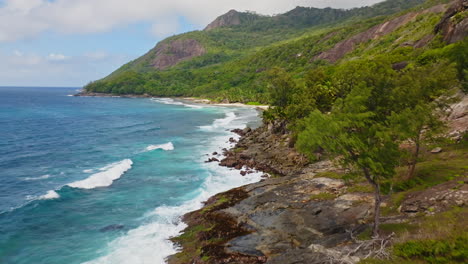 Aerial-drone-view-of-rocky-coastline-on-Silhouette-Island-in-the-Seychelles,-Indian-Ocean