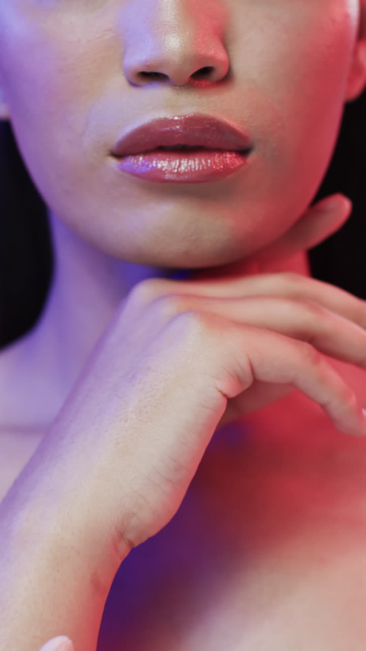 Vertical video of biracial woman with black hair and make up, copy space, slow motion