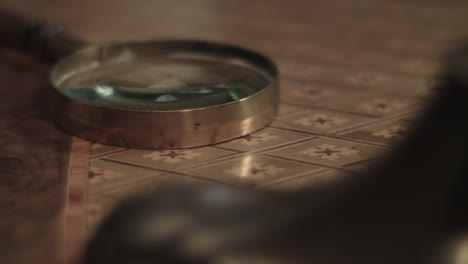 an older man picks up the loupe