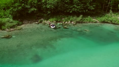 aerial view of a group sitting in the boat preparing for rafting in soca river.