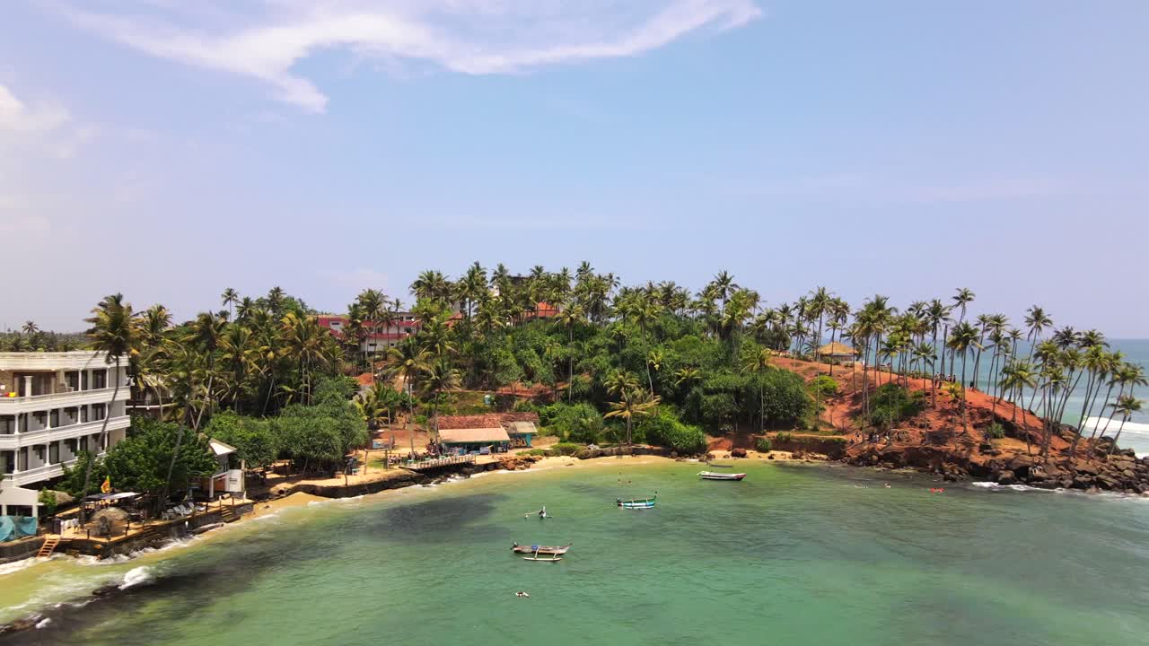 Exotic bay with turquoise water and modern hotel resort in Mirissa, Sri Lanka