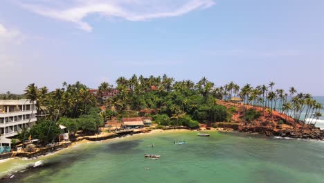 exotic bay with turquoise water and modern hotel resort in mirissa, sri lanka