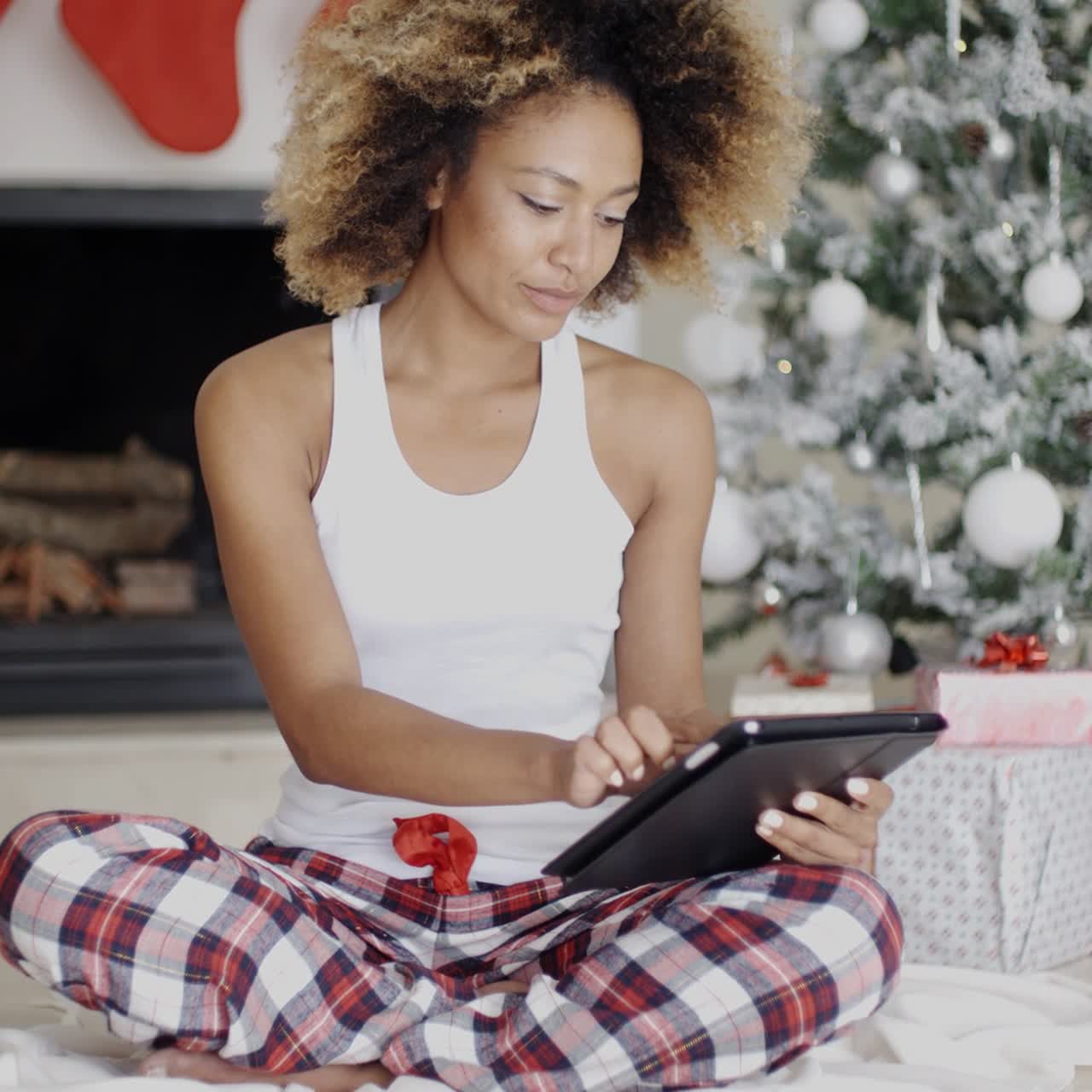 Thoughtful woman catching up on Christmas news