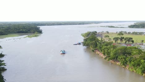 lonely touristic boat in vast river of bangladesh, aerial drone view