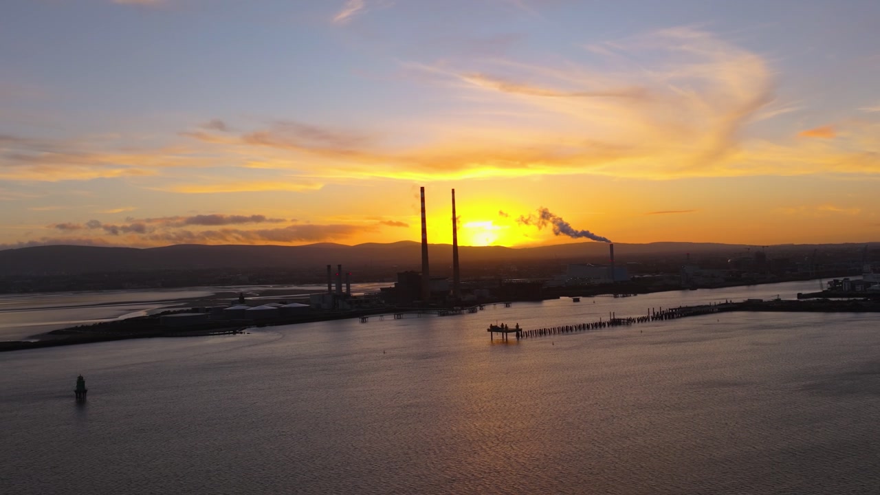 4K cinematic drone footage showcasing Poolbeg Lighthouse in Dublin during a breathtaking golden-hour sunset_05