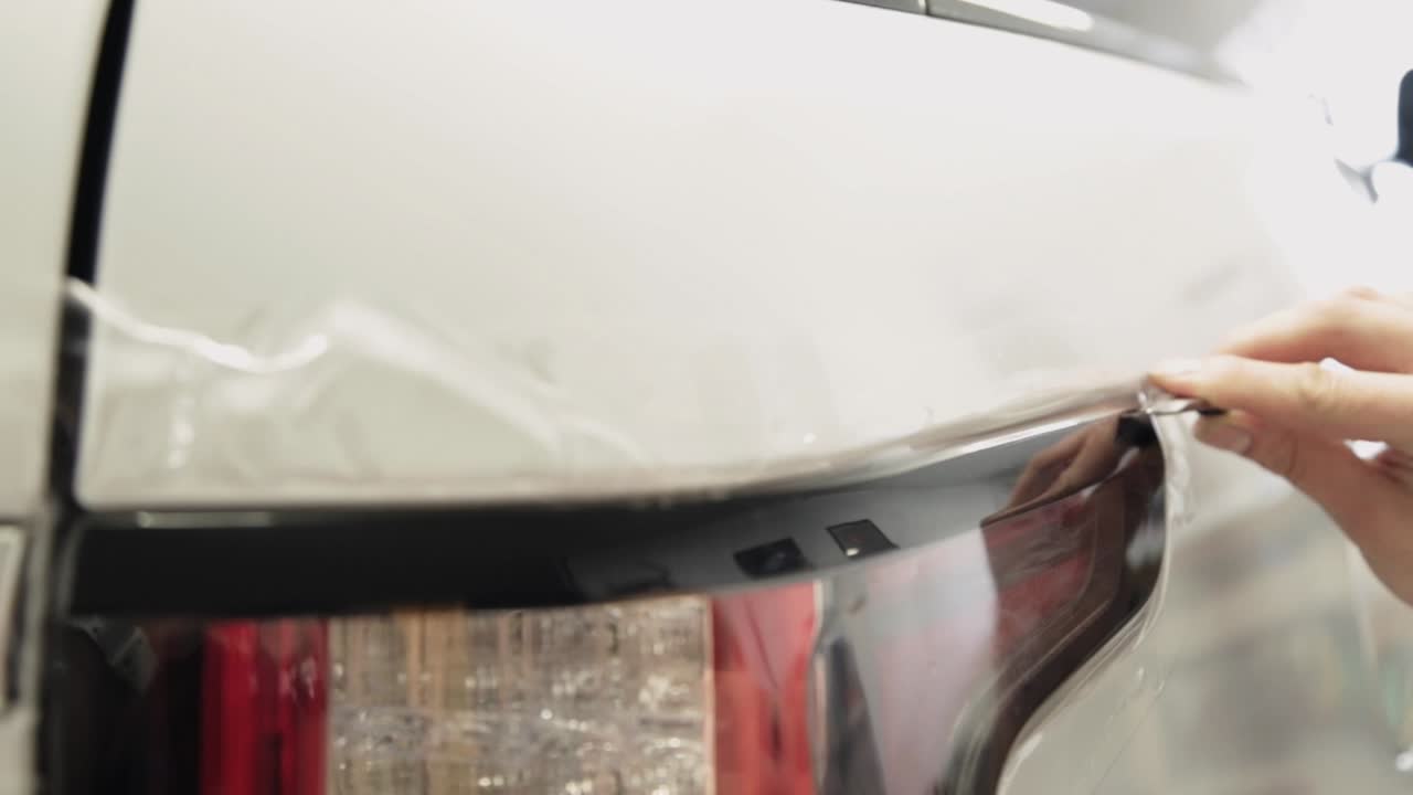 Beschermfolie aanbrengen op de achterklep van een auto