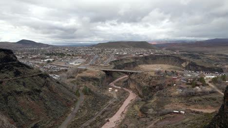 flying past a butte to view a bridge over the virgin river on utah state route 17 in la verkin