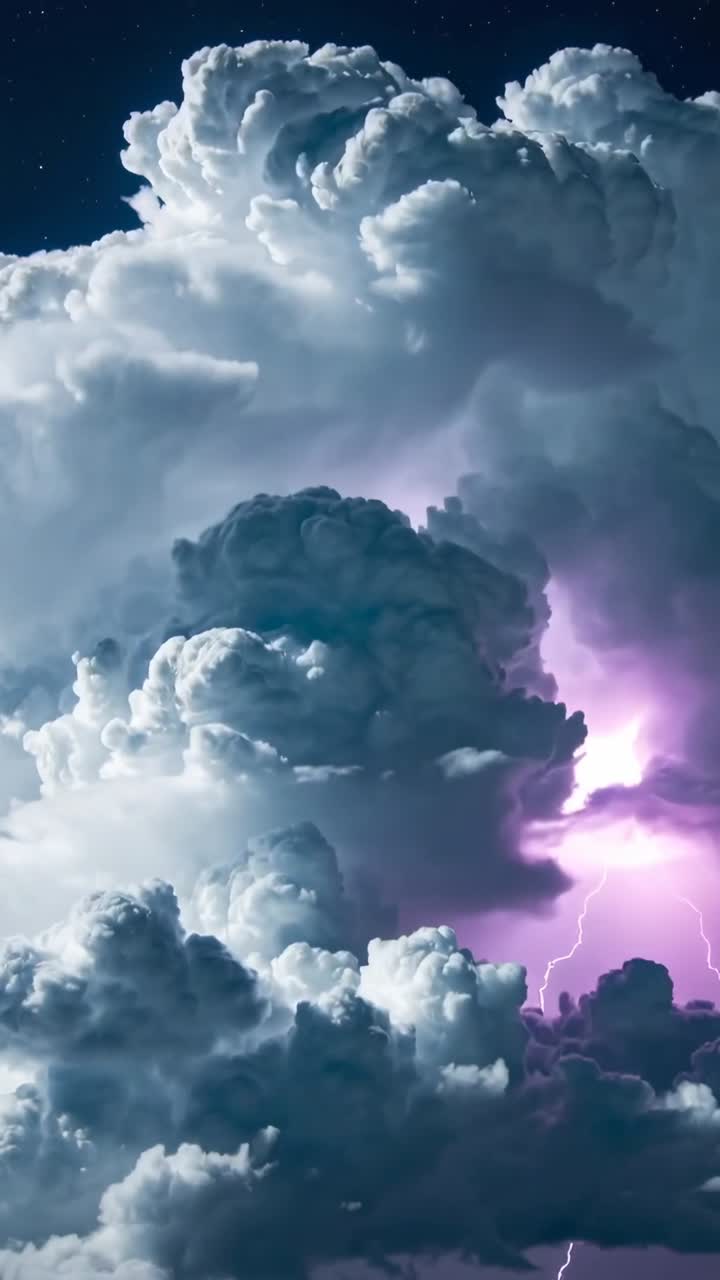 Vertical video: Flashing cumulonimbus cloud emitting internal flashes at night from purple glow