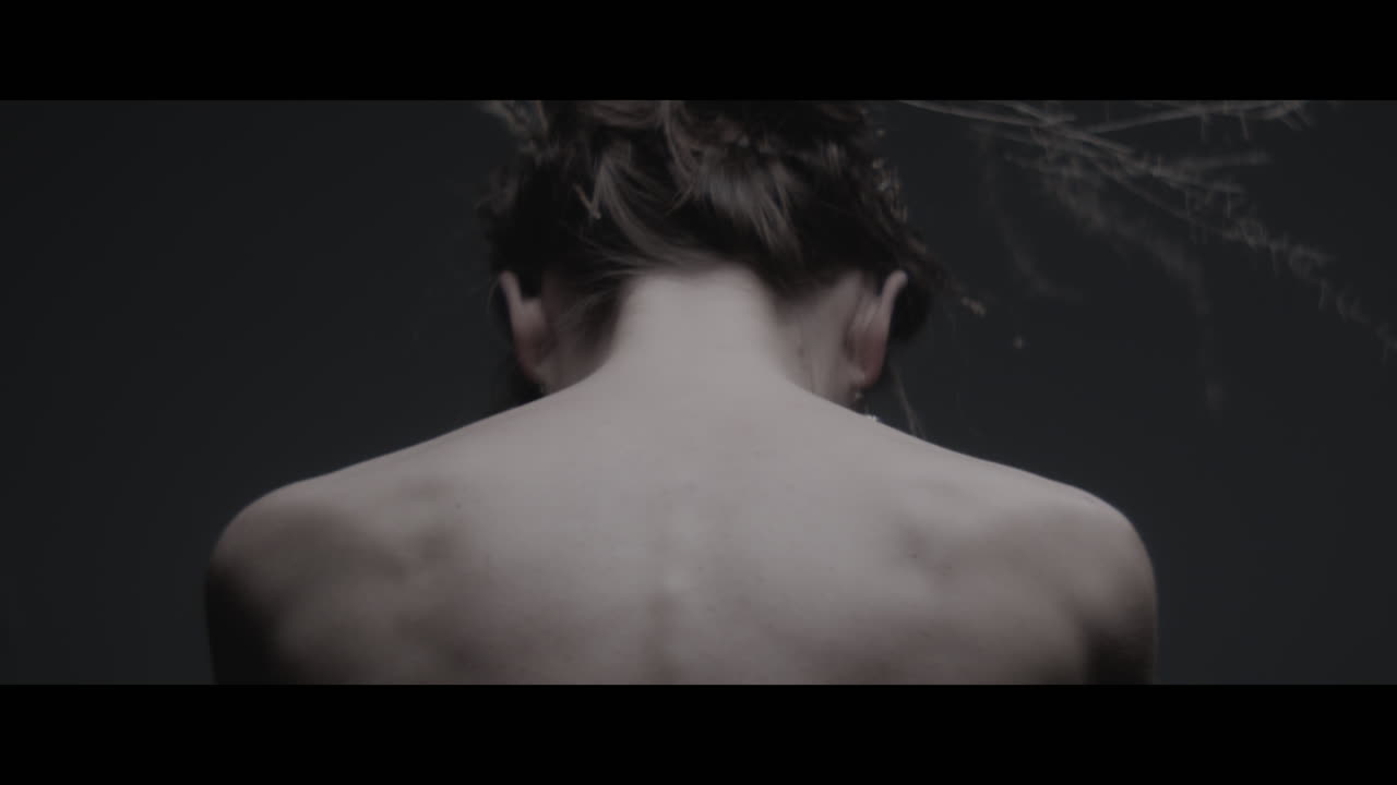 A woman dressed as mother nature shows her back