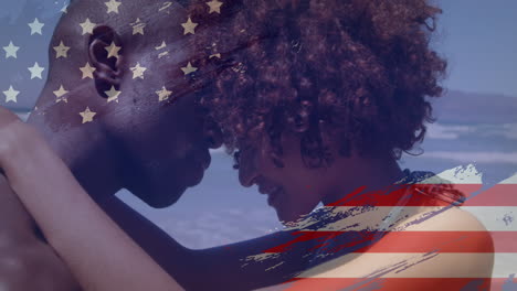 animation of usa flag design against african american couple embracing each other at the beach