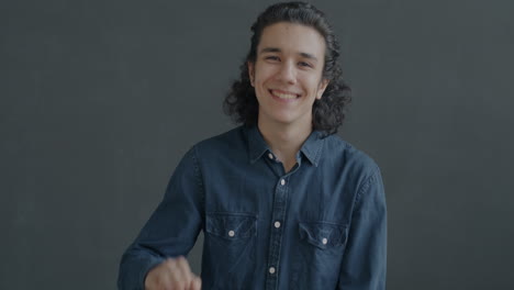 smiling teenager waving