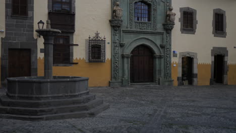 cinematographic shot of the fountain and the facade of the house of christopher columbus before his trip to america