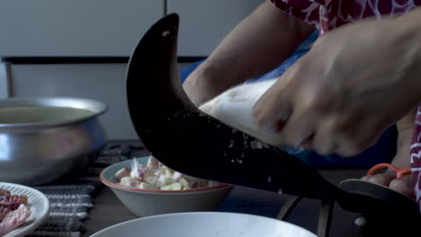 close-up hands of women cutting and peeling the fish into small pieces on eid al-adha at home