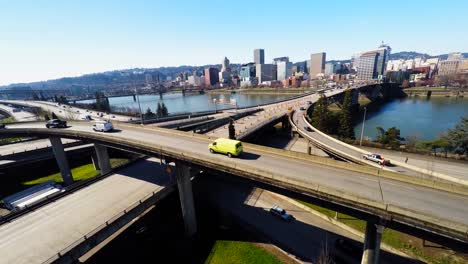 a rising aerial establishing shot of portland oregon bridge and city