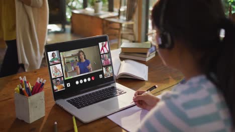 composite of girl using laptop for online lesson at home, with diverse teacher and class on screen