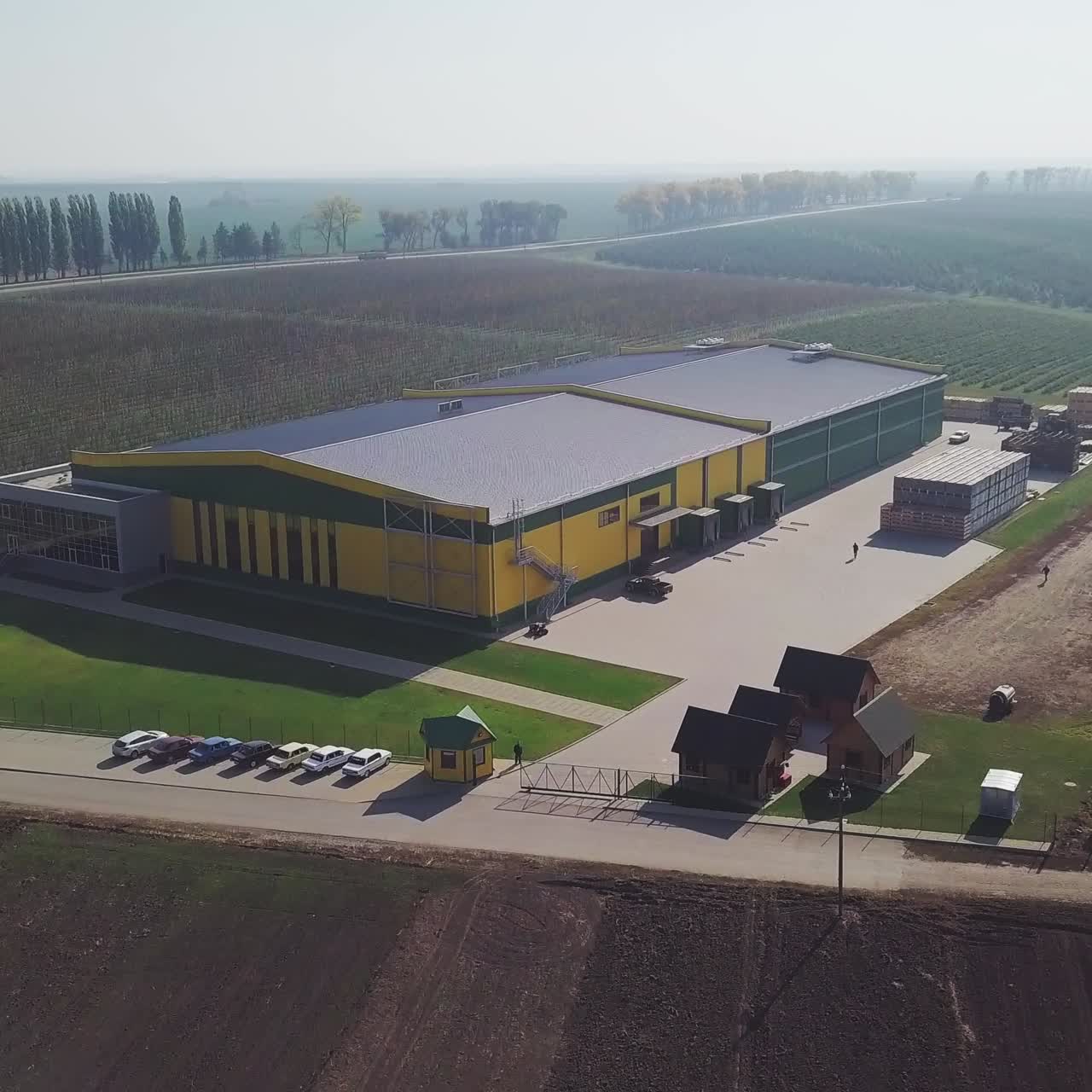 Aerial over fruit orchard farm showing different buildings to warehouse apples and pears also in background showing trees that grow the fresh fruit important food production site healthy food 4k