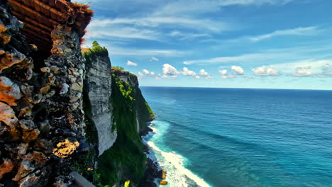 downwards view by the green-covered cliffs at nyang nyang beach on bali's south coast