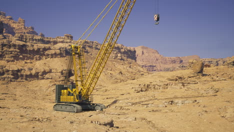 heavy machinery operates in a desert landscape during clear weather