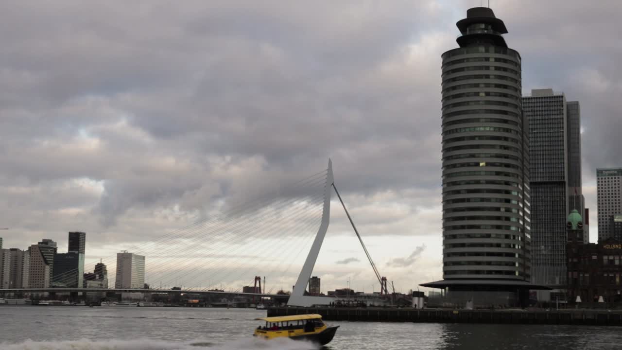 A Water Taxi Crosses the River in Rotterdam before the Famous Erasmus Bridge!