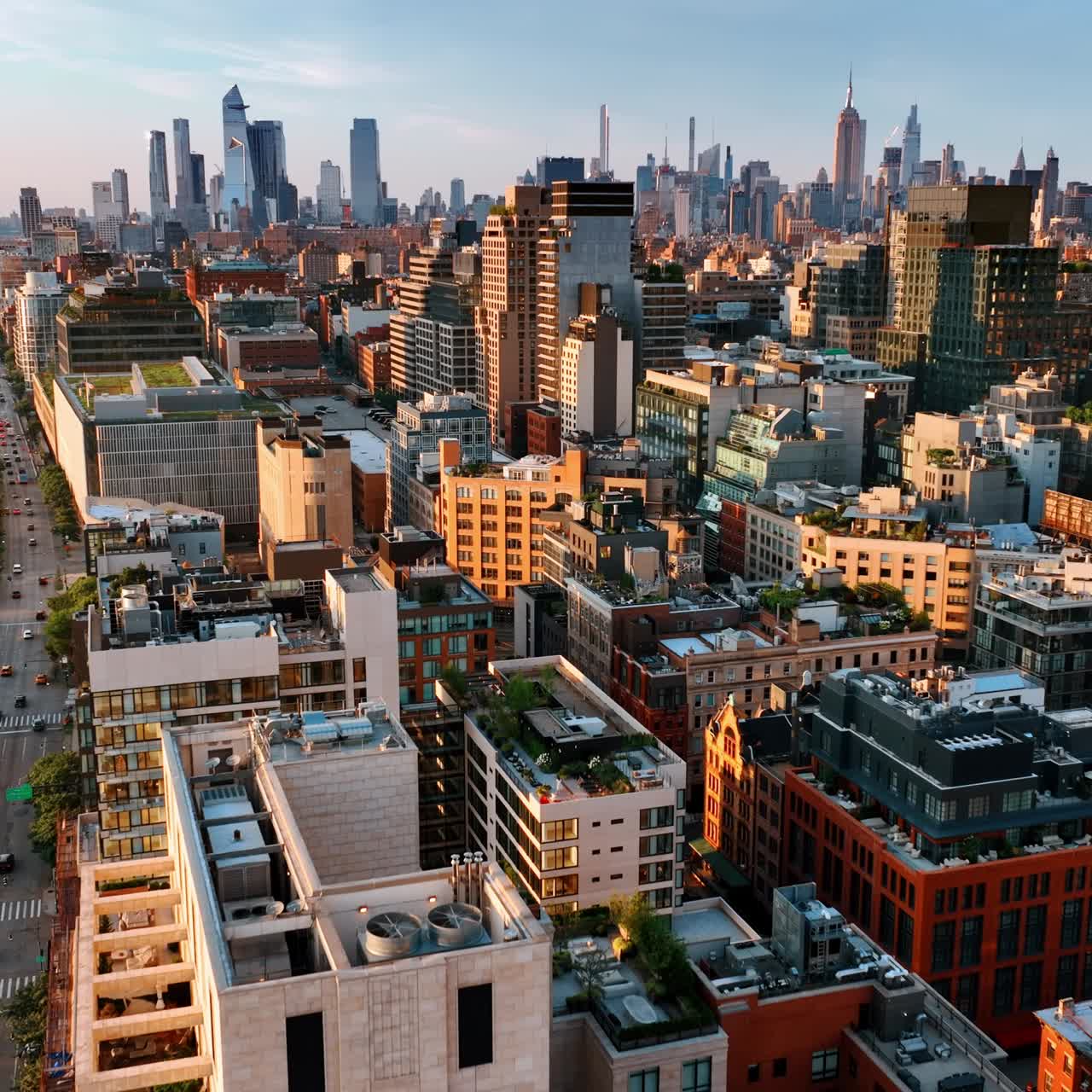 Sunlit facades of the various buildings in New York architecture. Cozy houses with gardens and lounge zones on the tops. Aerial view