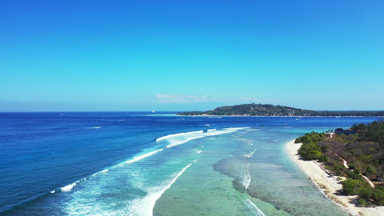 Island hopping concept. Waves rolling on the sandy shore. gili islands Bali