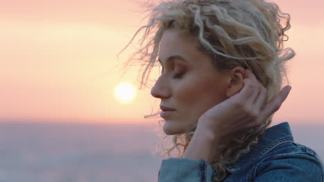 portrait of beautiful woman enjoying peaceful seaside at sunset contemplating journey exploring spirituality feeling freedom with wind blowing hair