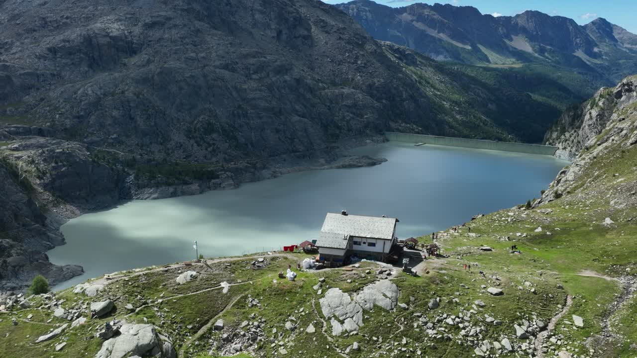 Aerial pullin Drone Shot of Bignami's Hut over Gera's Dam - Valmalenco - Sondrio