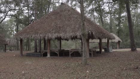 panning shot of wooden village huts in a public area at stephen c foster culture center in florida in 4k 29.97p