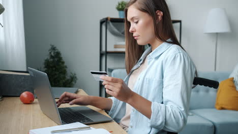 woman online shopping from home in wheelchair