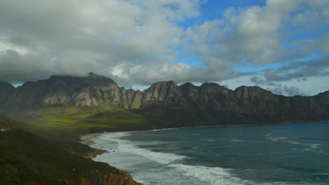 the beach and surrounding mountain range with no