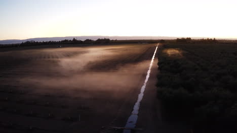 Aerial View of Agricultural Fields with Mist and Irrigation Canal