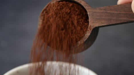 preparing coffee with a wooden measuring spoon