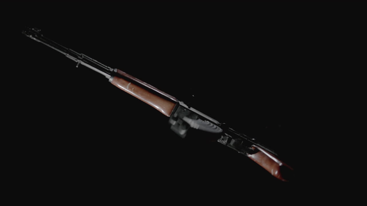 Machineguns on the dark background and in blinking rotate in slowmotion