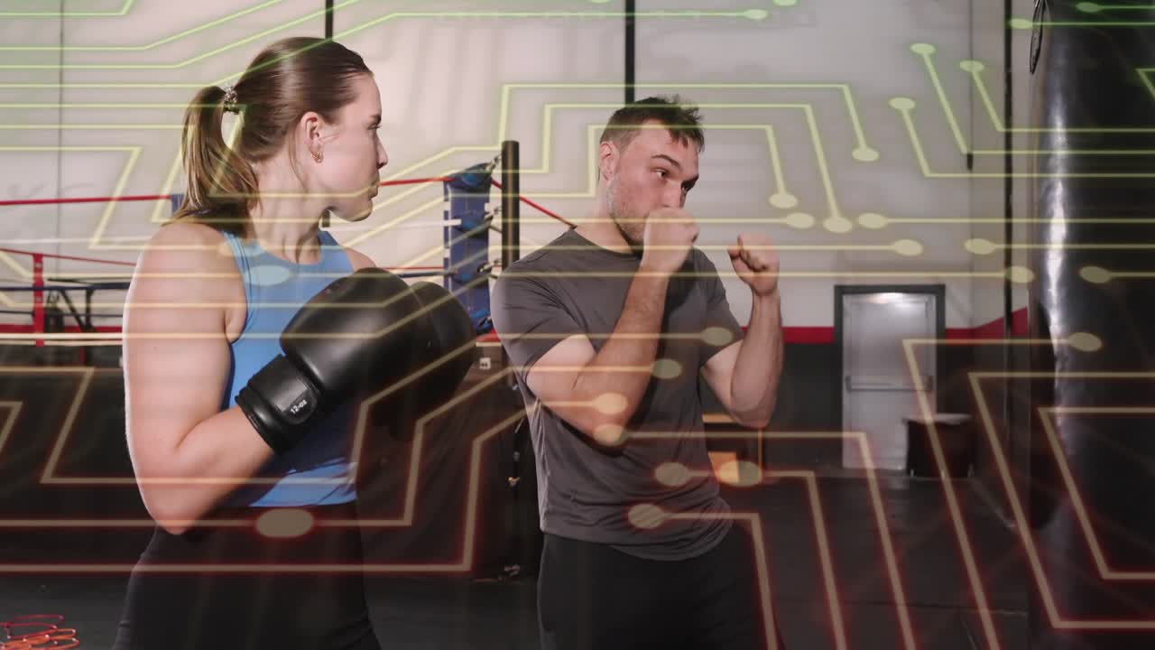 Coach cueing trainee practicing jabs on bag for boxing form, faint circuit overlay partly obscuring