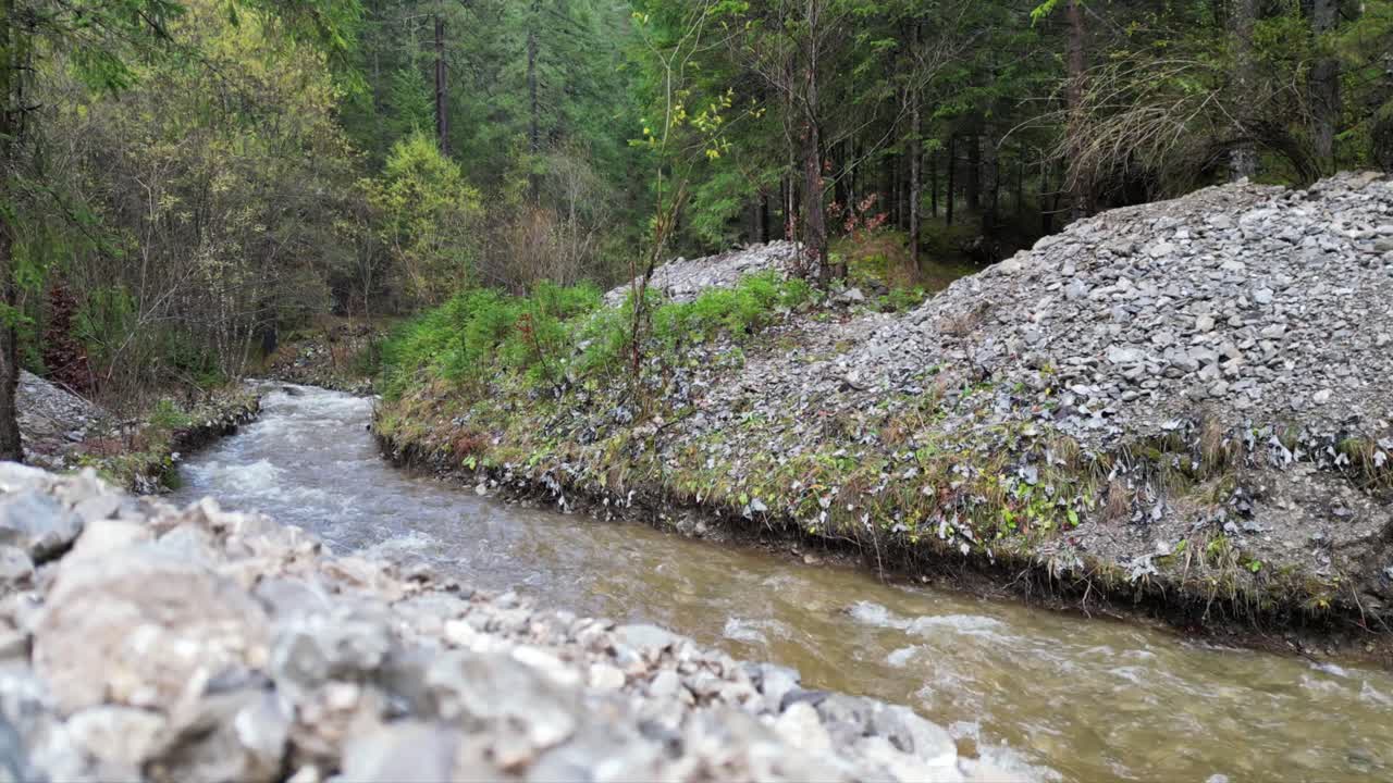A winding river flowing through a rocky forest